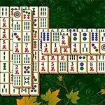 Mahjong csempe elrendezés zöld háttérrel és sárga levelekkel az alján